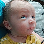 Elijah is registered to the contest to win money with this photo: baby, child, face, portrait, expression, side_eye, hair, yellow_clothing, striped, skin, infant, person, indoors, bed, pillow, closeup, cute, young, head, sitting