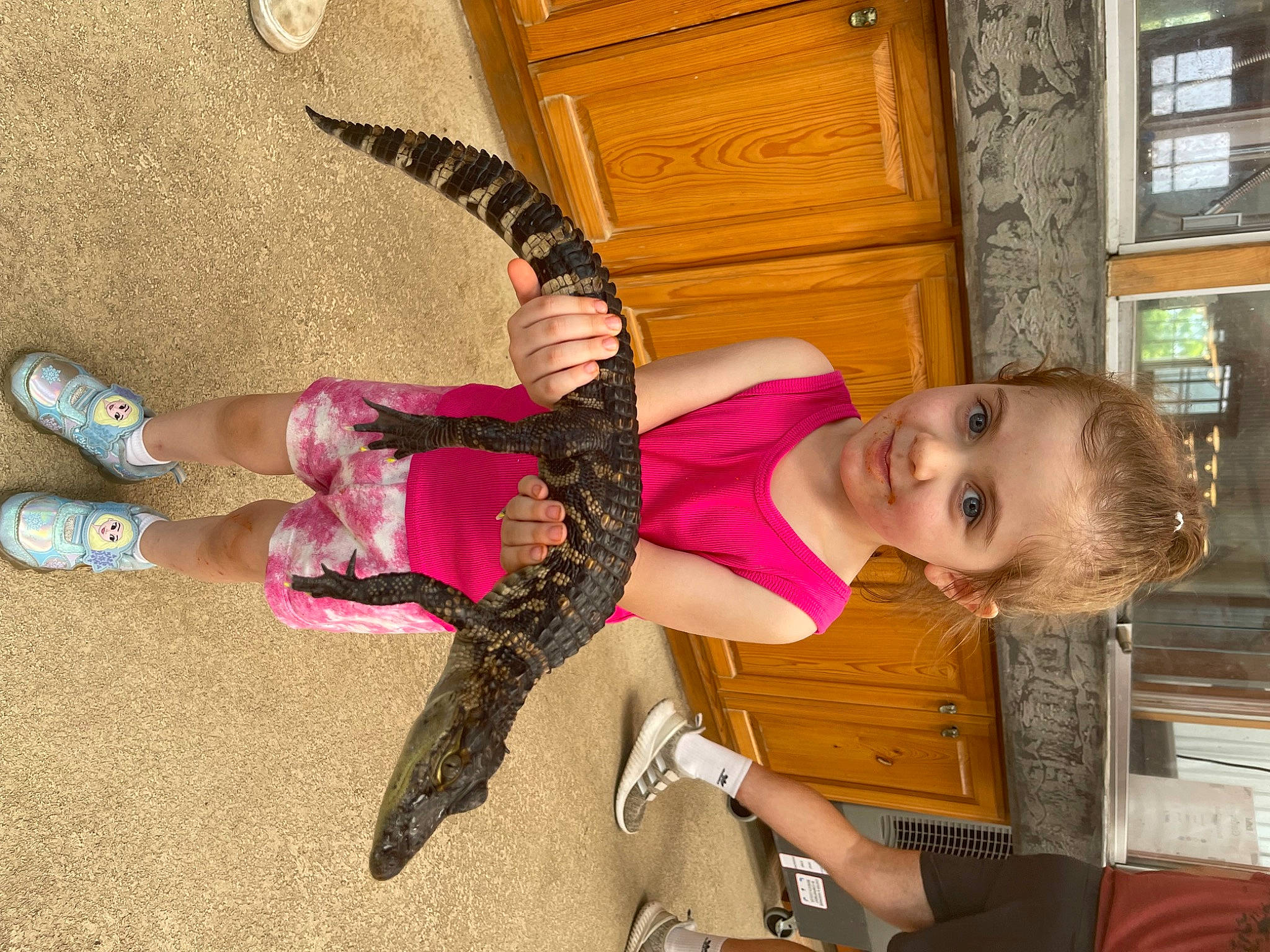 Juniper is registered to the contest to win money with this photo: arm, cabinetry, door, fun, happy, human_leg, joint, joy, magenta, person, picture_frame, pink, purple, room, sandal, shoe, smile, textile, thigh, walking_shoe