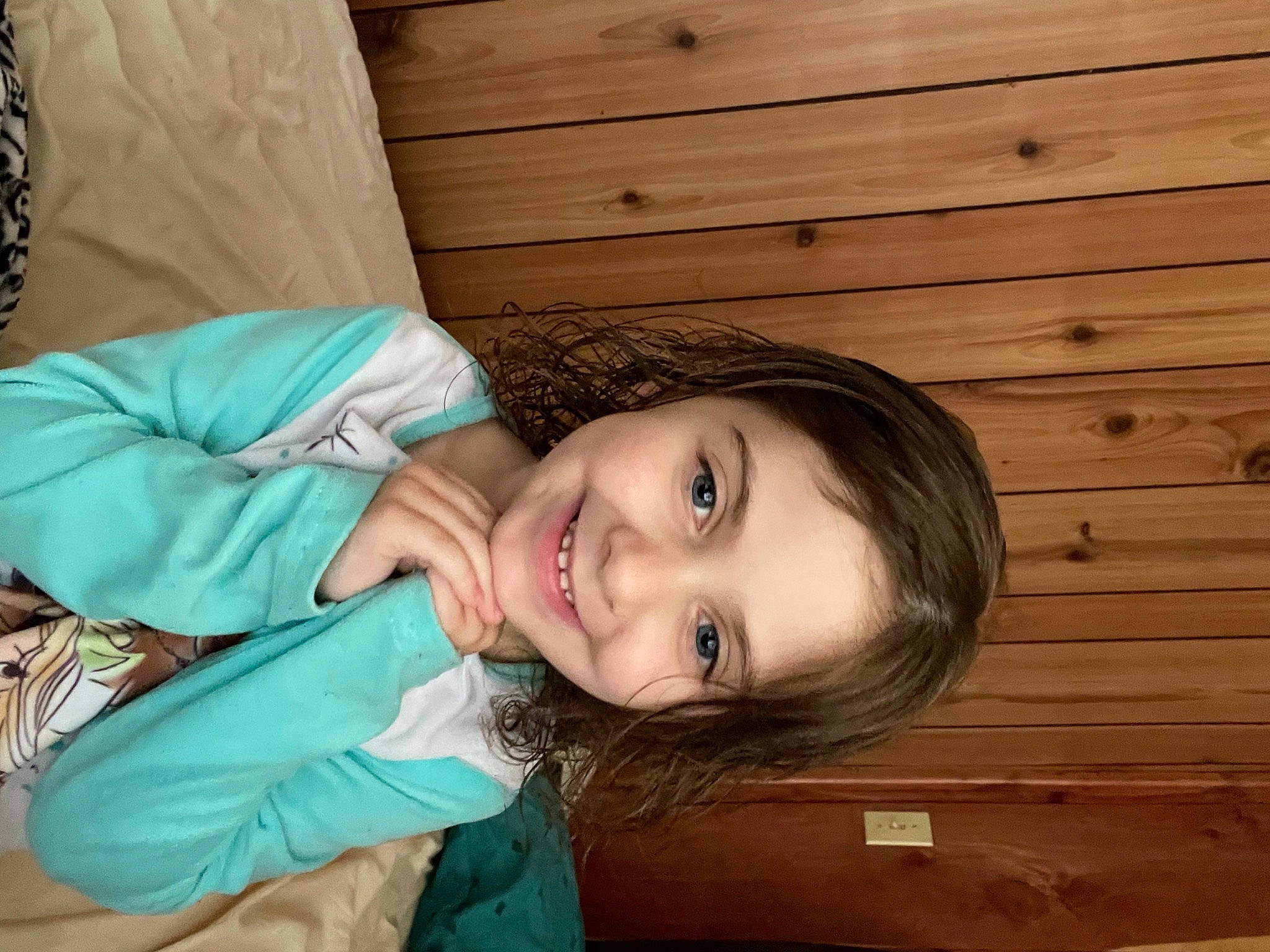 Juniper is registered to the contest to win money with this photo: black_hair, brown_hair, cheek, child, eye, eyelash, flash_photography, grass, happy, hardwood, head, joy, lip, long_hair, lumber, nose, person, sitting, skin, smile