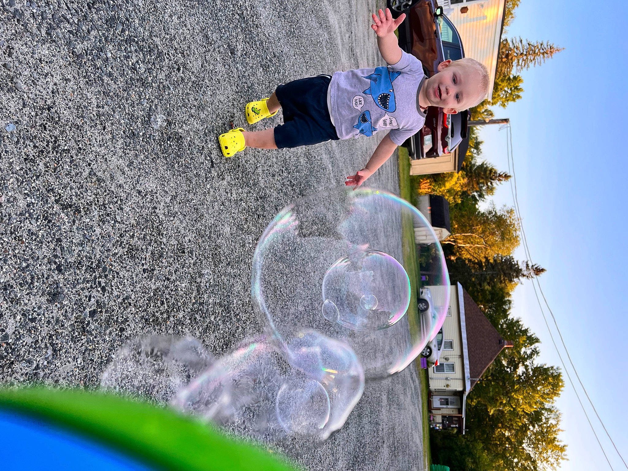 Anderson is registered to the contest to win money with this photo: adventure, asphalt, concrete, extreme_sport, font, fun, grass, joy, leisure, person, pole, recreation, sky, t_shirt, toddler, tree, walking_shoe, white, yellow