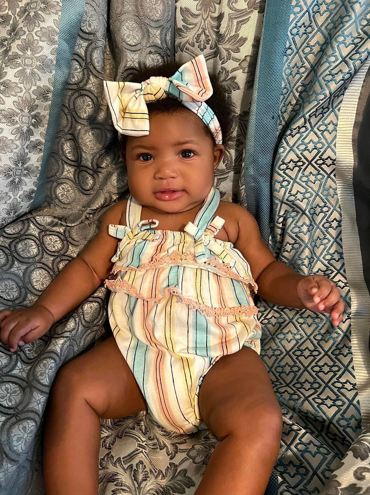 Kinsley is registered to the contest to win money with this photo: baby, baby_toddler_clothing, chair, child, chin, cool, dress, eye, fashion_accessory, fun, happy, headwear, human_leg, iris, pattern, person, purple, sitting, skin, sun_hat