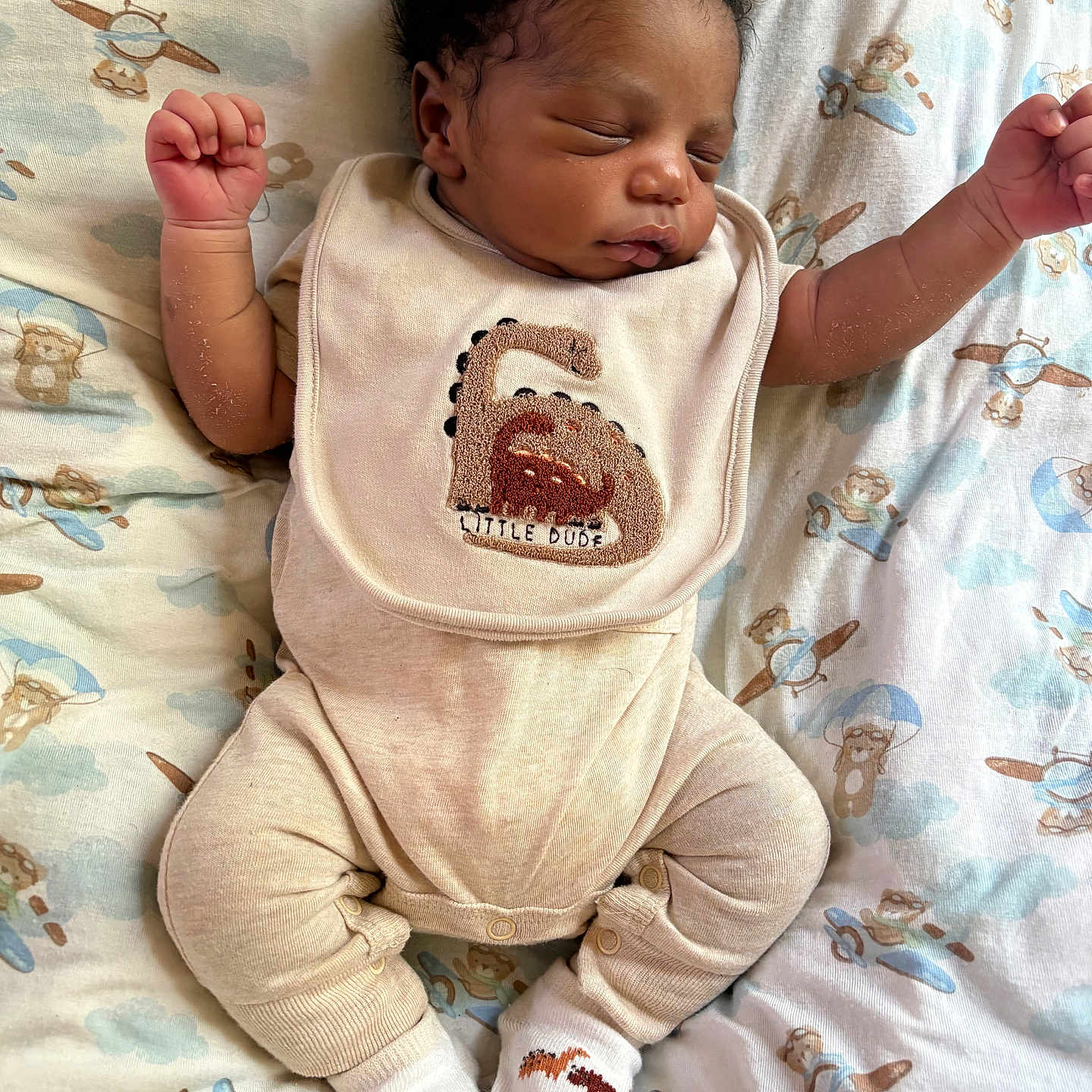 Jream joined the competition — help win amazing prizes! baby, sleeping, infant, bib, clothing, patterned_sheet, teddy_bear, airplane, arms_up, cozy, cute, newborn, socks, peaceful, resting, soft_texture, child, portrait, indoors, laying_down