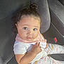 Skylar joined the competition — help win amazing prizes! baby, child, infant, car_seat, clothing, pajamas, dinosaur_pattern, topknot, bib, cute, face, hands, sitting, indoors, seatbelt, car_interior, person, young_child, looking_at_camera, expression
