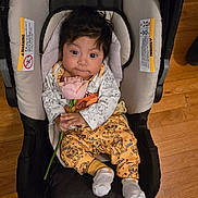Ricardo Jasiel joined the competition — help win amazing prizes! baby, car_seat, flower, rose, wooden_floor, slippers, indoor, child, cute, clothing, person, infant, smiling, holding, floor, home, portrait, seated, toy_pattern, footwear