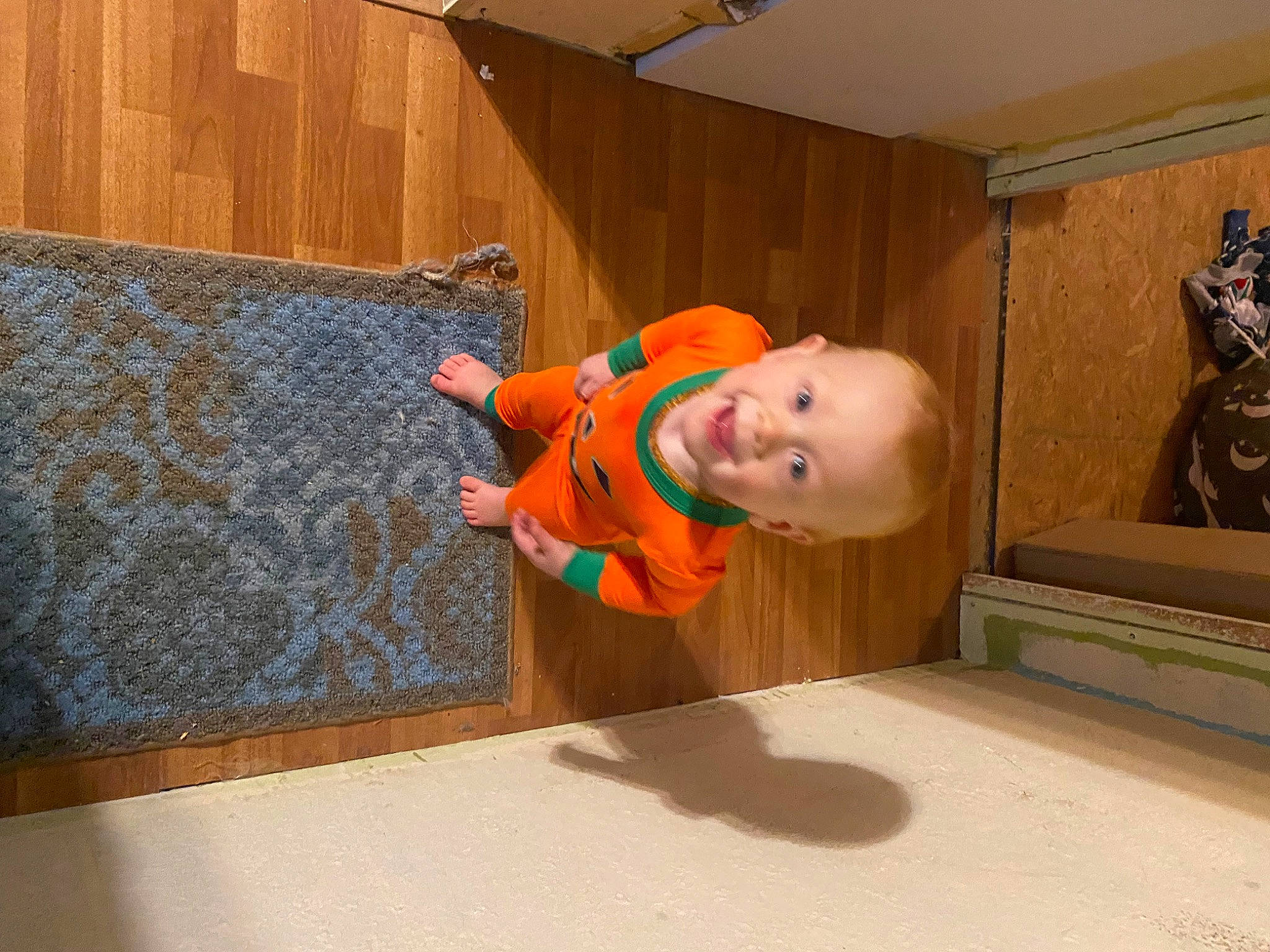 Arthur is registered to the contest to win money with this photo: baby, baby_toddler_clothing, child, floor, flooring, fun, hardwood, hat, house, person, room, smile, toddler, varnish, wood, wood_stain
