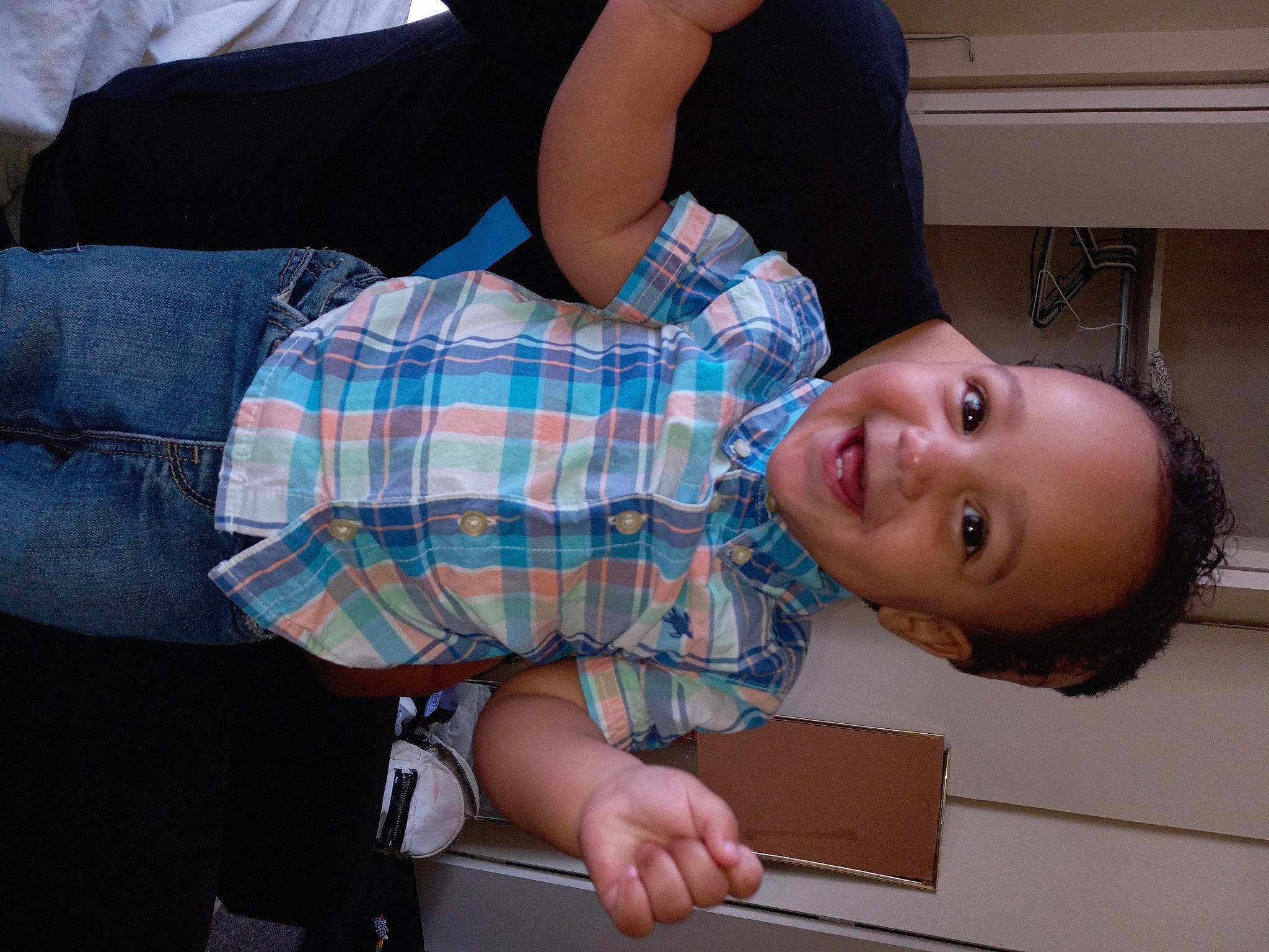 Uziah is registered to the contest to win money with this photo: child, comfort, elbow, fun, glasses, happy, human_leg, joy, knee, pattern, person, plaid, room, sitting, smile, sock, tartan, thigh, toddler, tree