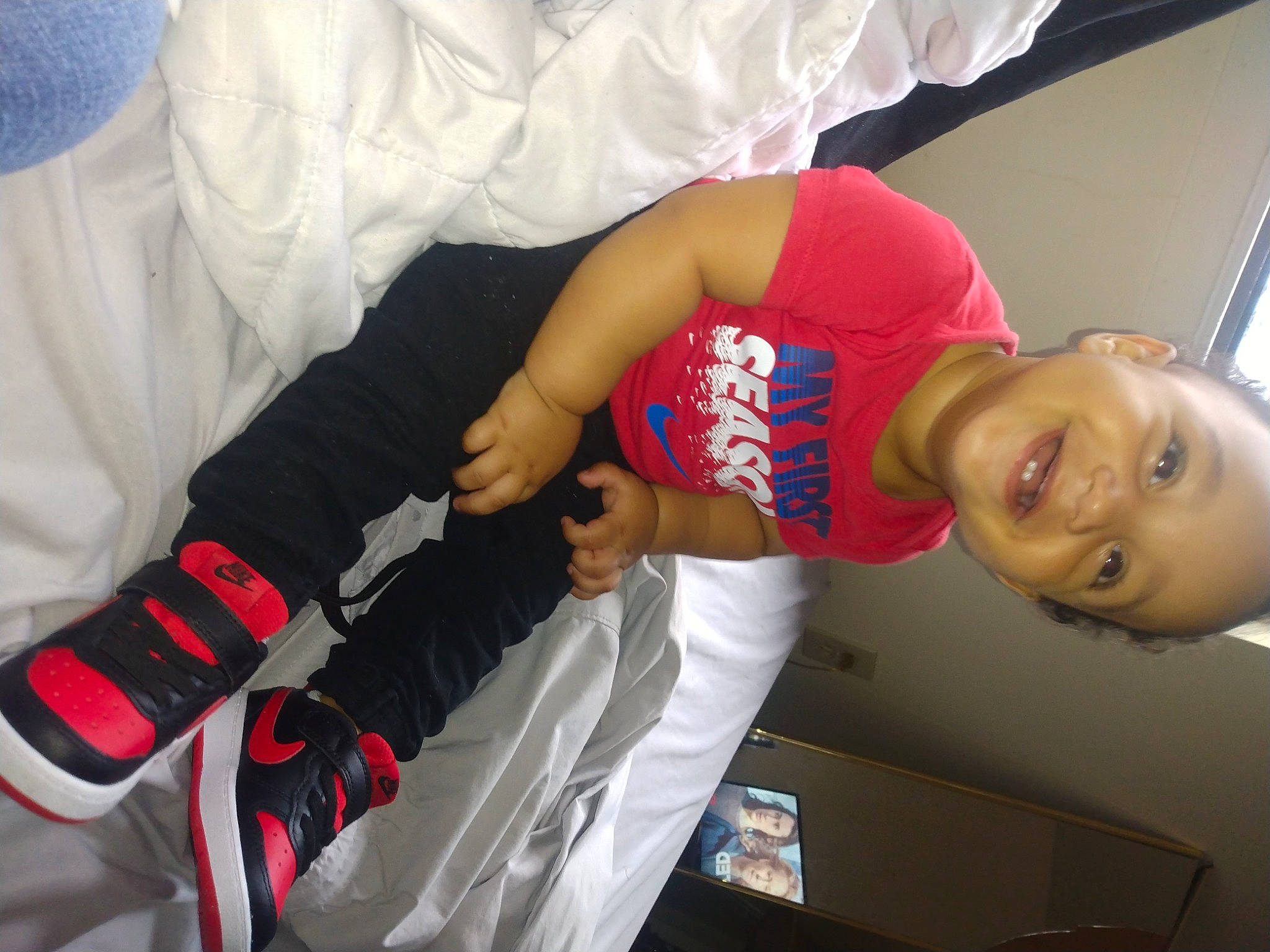 Uziah is registered to the contest to win money with this photo: arm, child, comfort, elbow, finger, gesture, glove, happy, joint, joy, karate, person, room, sleeve, smile, t_shirt, wrist