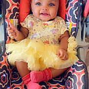 Evver is registered to the contest to win money with this photo: baby, infant, smiling, yellow_tutu, headband, car_seat, pink_socks, patterned_fabric, cute, happy, child, portrait, indoors, seated, adorable, cloth, baby_girl, fashion, accessory, small_child