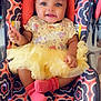 baby, infant, smiling, yellow_tutu, headband, car_seat, pink_socks, patterned_fabric, cute, happy, child, portrait, indoors, seated, adorable, cloth, baby_girl, fashion, accessory, small_child