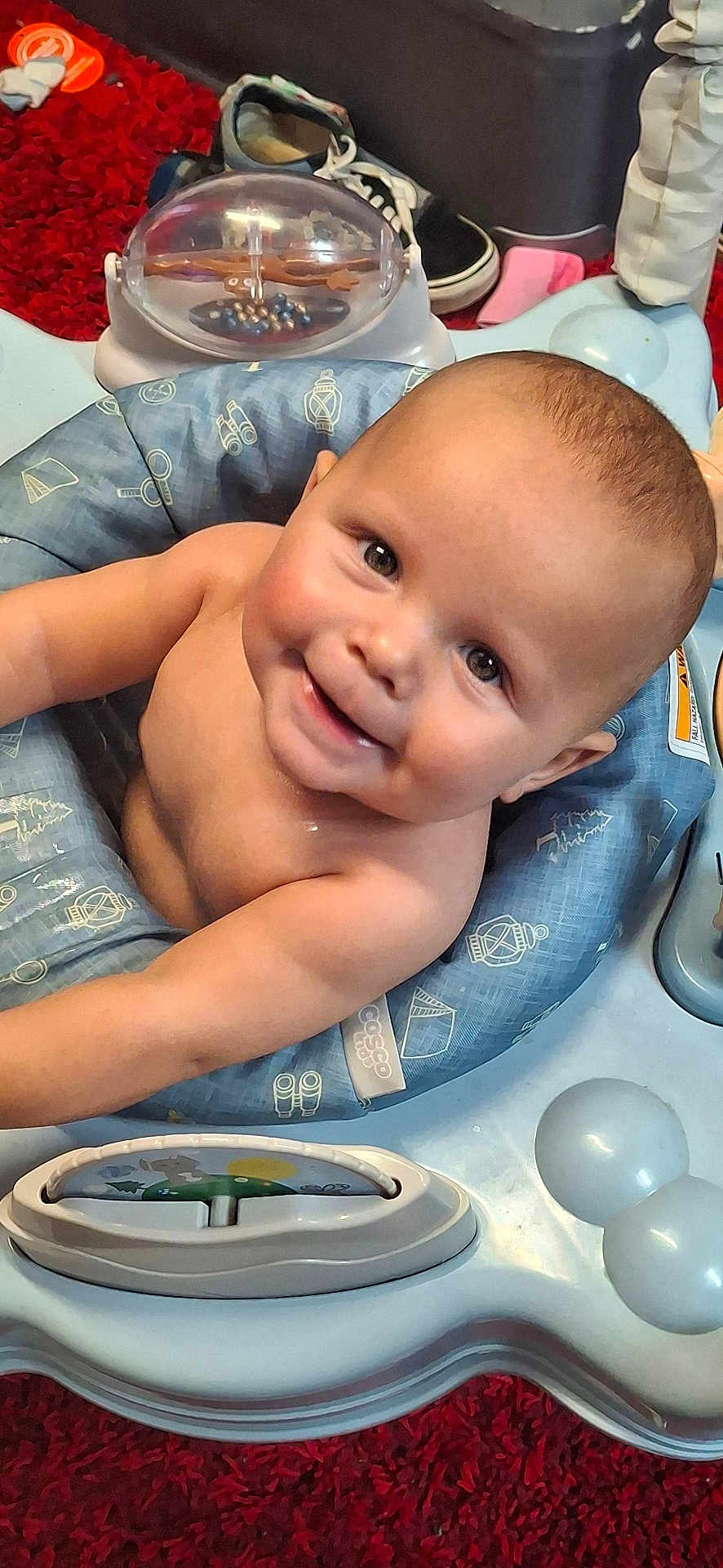 Johnnie joined the competition — help win amazing prizes! baby, bare_chest, blue_cushion, cheeks, child, cute, eyes, face, happy, head, indoor, infant, person, play_area, red_carpet, seat, skin, smiling, toy, young_child