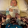 Waylon is registered to the contest to win money with this photo: baby, bed, blanket, child, closeup, clothing, couch, cozy, indoor, infant, leg_braces, medical_braces, onesie, pacifier, pillow, portrait, relaxed, sharks, shoes, sleeping