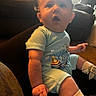 Waylon is registered to the contest to win money with this photo: baby, blue_outfit, car_seat, child, face, hair, indoors, infant, onesie, open_mouth, photography, pointing, portrait, seatbelt, shoes, sitting, socks, surprised, vehicle, wide_eyed