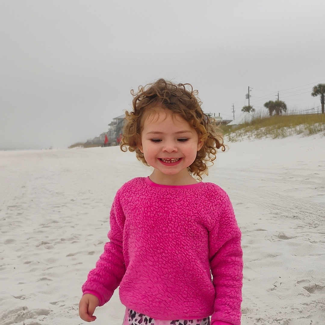 Adalynn is registered to the contest to win money with this photo: child, clothing, face, female, girl, happy, head, knitwear, longsleeve, nature, outdoors, pants, person, photography, portrait, sea, sleeve, smile, sweater, water