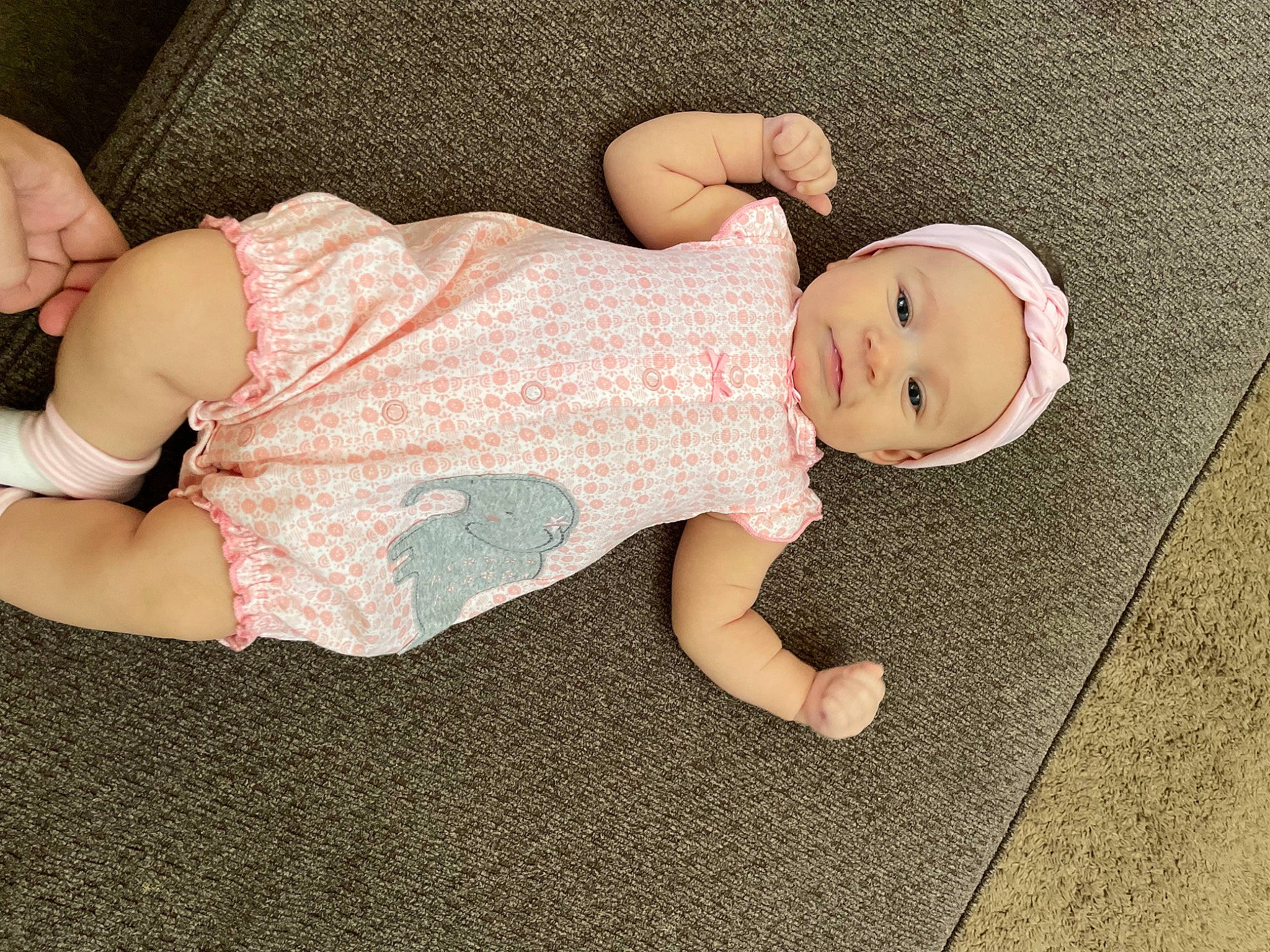 Avaeyah is registered to the contest to win money with this photo: arm, baby, baby_toddler_clothing, cheek, comfort, eye, face, finger, foot, hand, head, headgear, headwear, human_body, joint, leg, person, pink, skin, sleeve