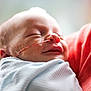 baby, sleeping, newborn, blanket, medical_tube, face, infant, closeup, peaceful, child, person, soft_light, indoors, wrapped, skin, mouth, nose, head, tape, comfort