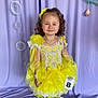 bow, bubbles, child, childhood, costume, curly_hair, cute, dress_up, fashion, frilly_socks, girl, happy, indoor, pageant, portrait, purple_backdrop, smile, standing, white_shoes, yellow_dress