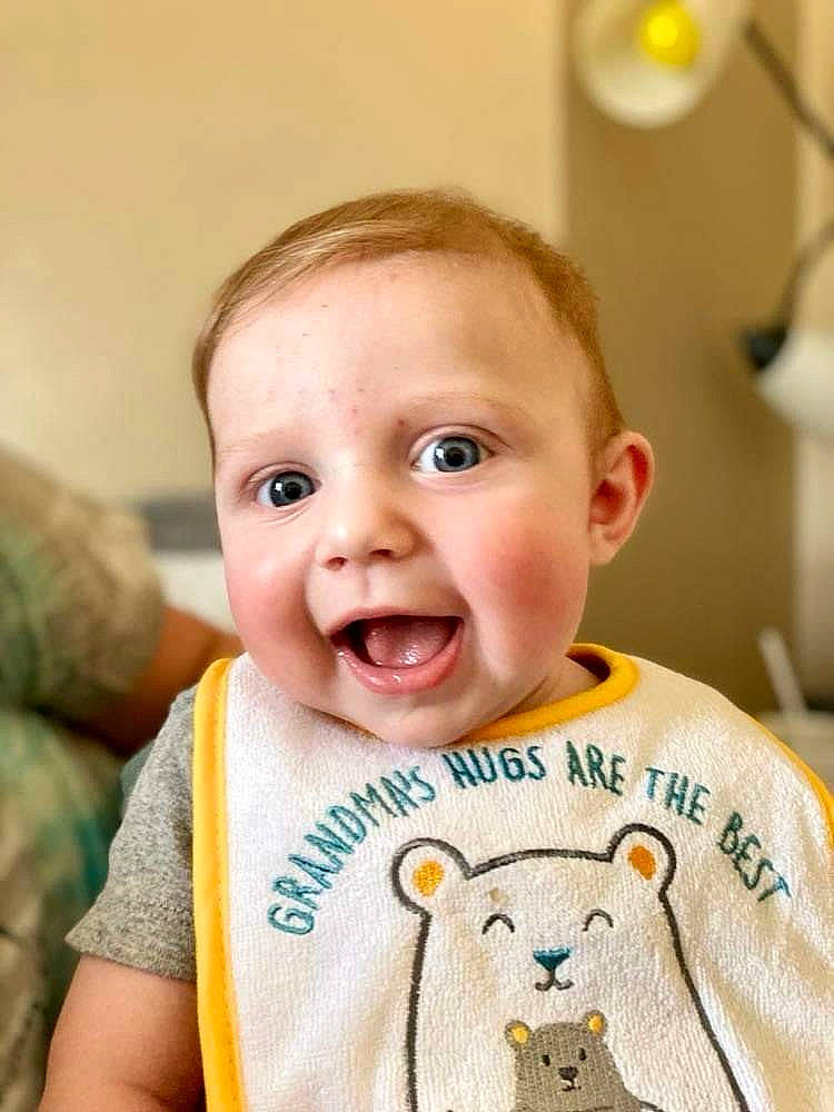 Cayden is registered to the contest to win money with this photo: baby, baby_toddler_clothing, cheek, clothing, ear, eye, eyebrow, eyelash, face, happy, head, iris, mouth, neck, nose, person, skin, sleeve, smile, t_shirt