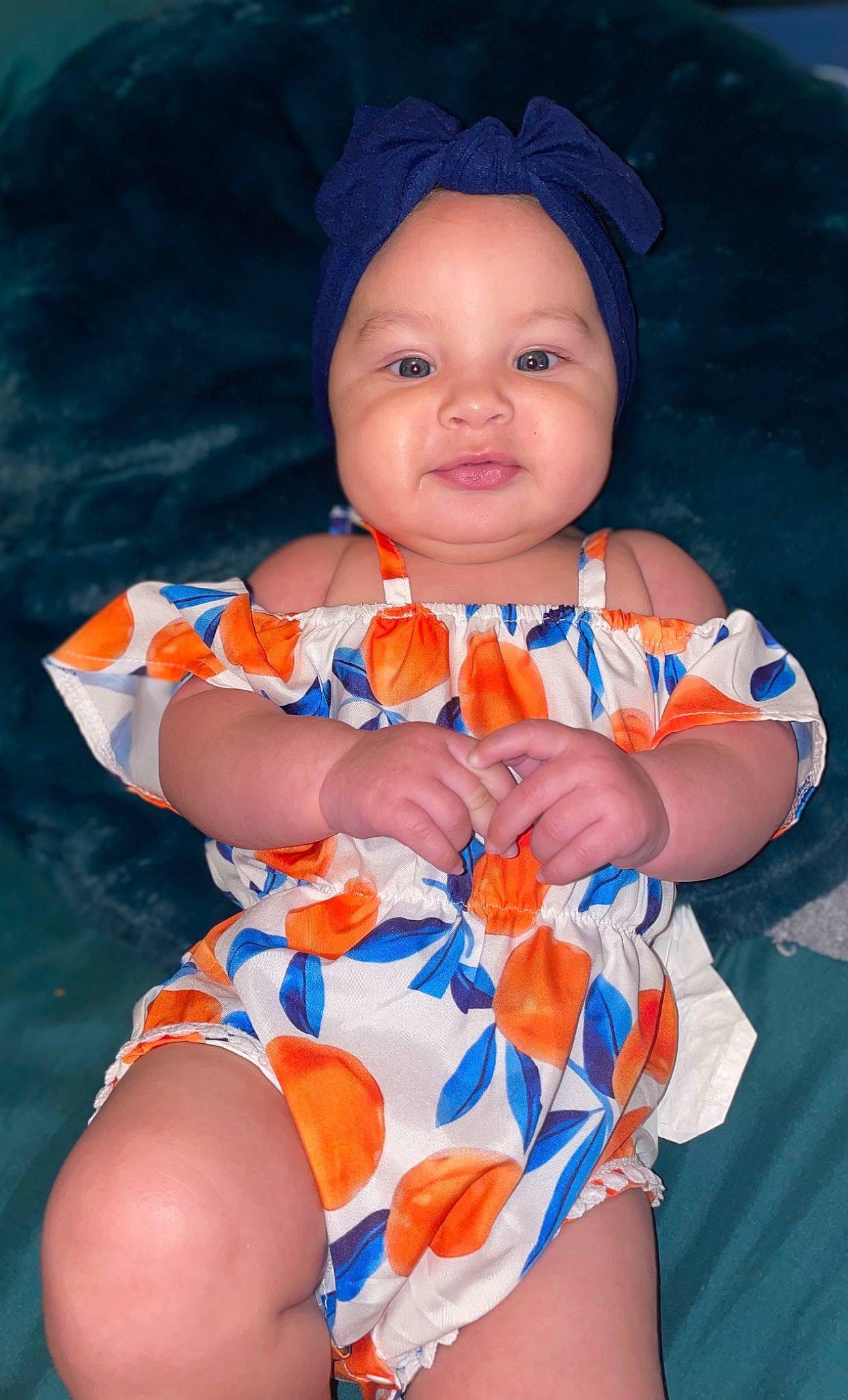 Zelena is registered to the contest to win money with this photo: aqua, baby, baby_toddler_clothing, blue, cheek, eye, finger, hand, happy, headgear, headwear, orange, organ, person, pink, product, skin, sleeve, smile, textile
