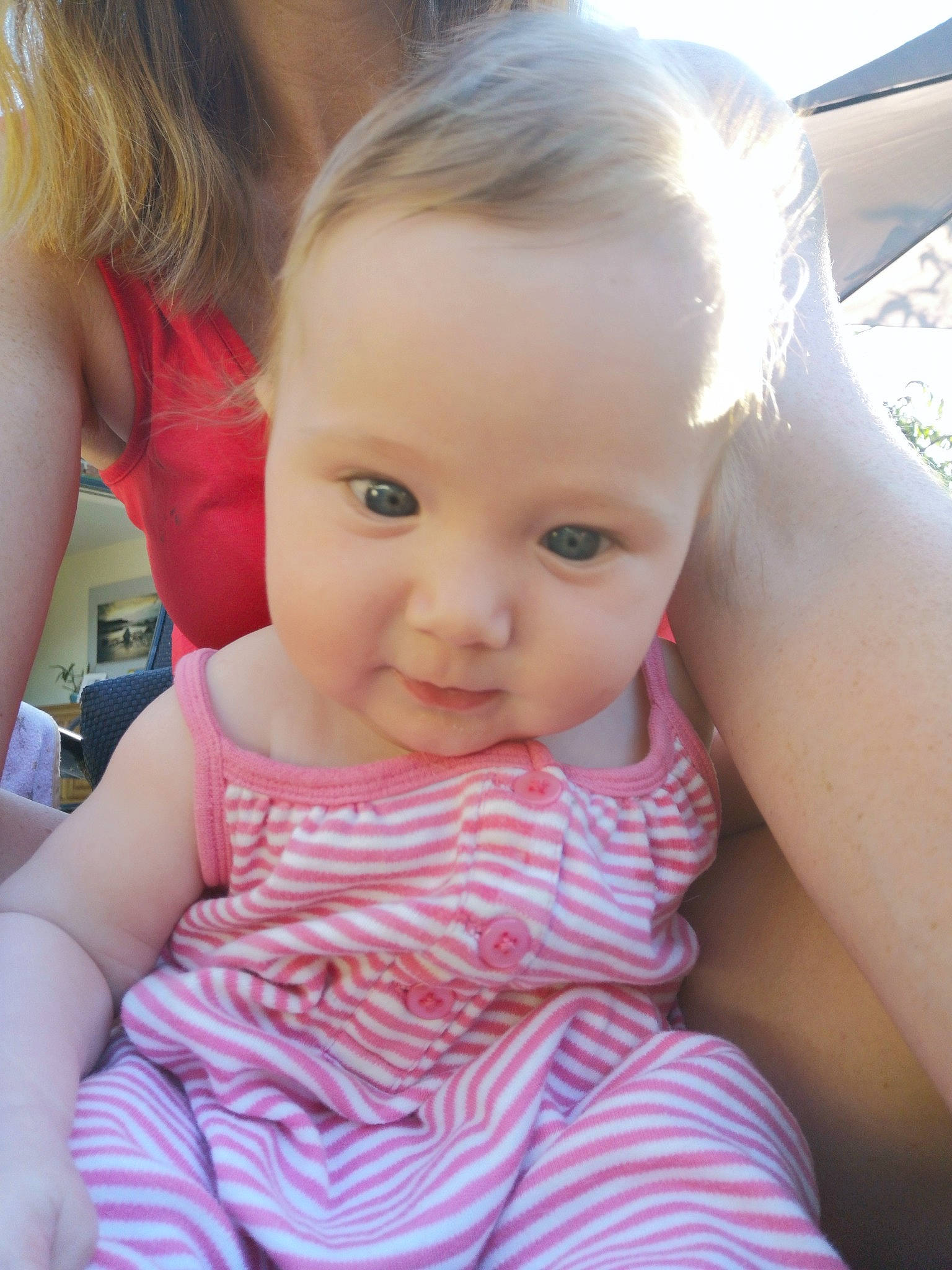 Isla is registered to the contest to win money with this photo: baby_toddler_clothing, cheek, chin, ear, eyebrow, eyelash, facial_expression, gesture, hair, happy, iris, lip, neck, nose, person, pink, shoulder, skin, smile, summer