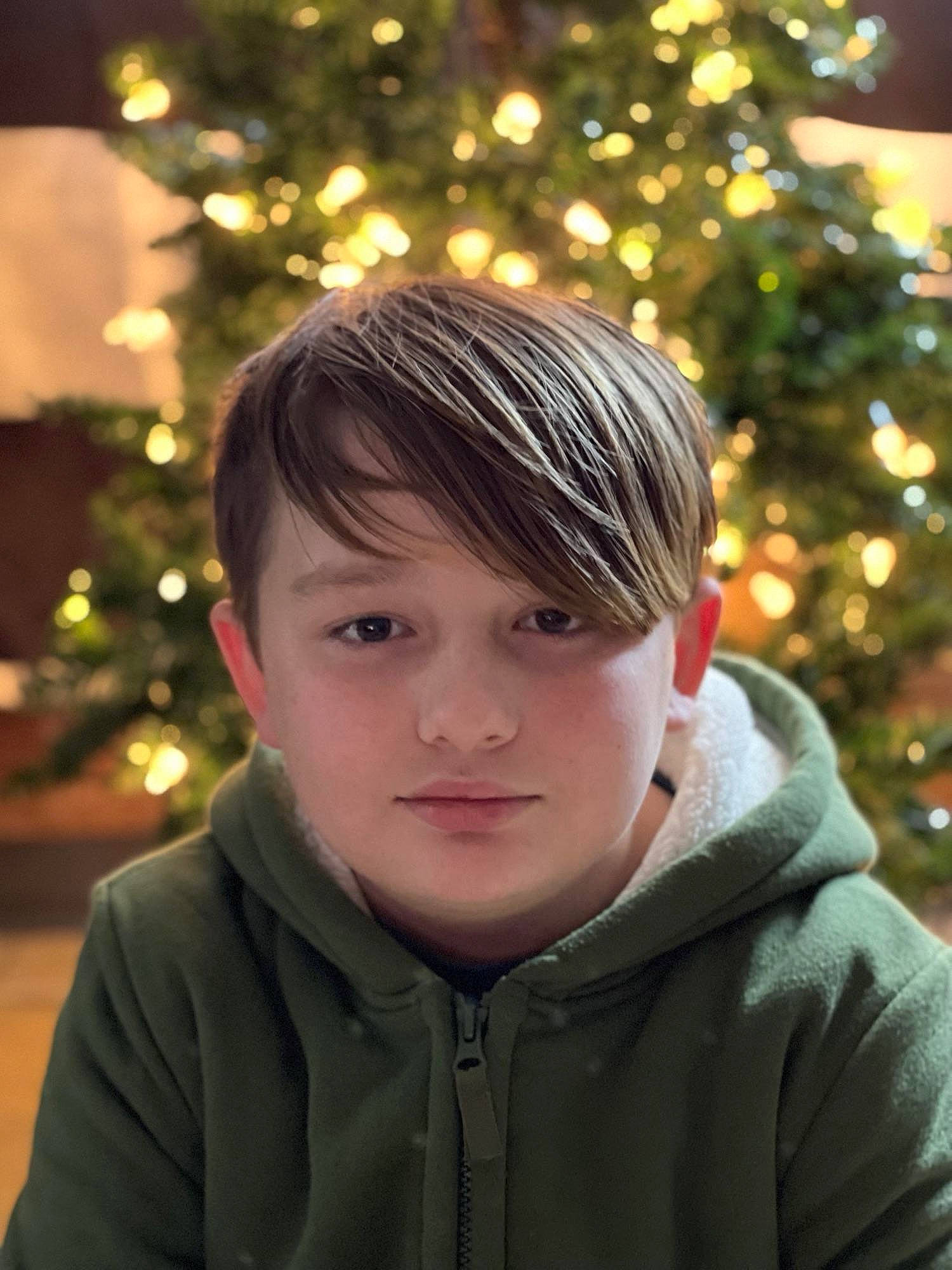 Aiden is registered to the contest to win money with this photo: beauty, christmas_ornament, christmas_tree, cool, eye, facial_expression, flash_photography, fun, hair, happy, head, holiday_ornament, light, organ, outerwear, people_in_nature, person, plant, standing, tree