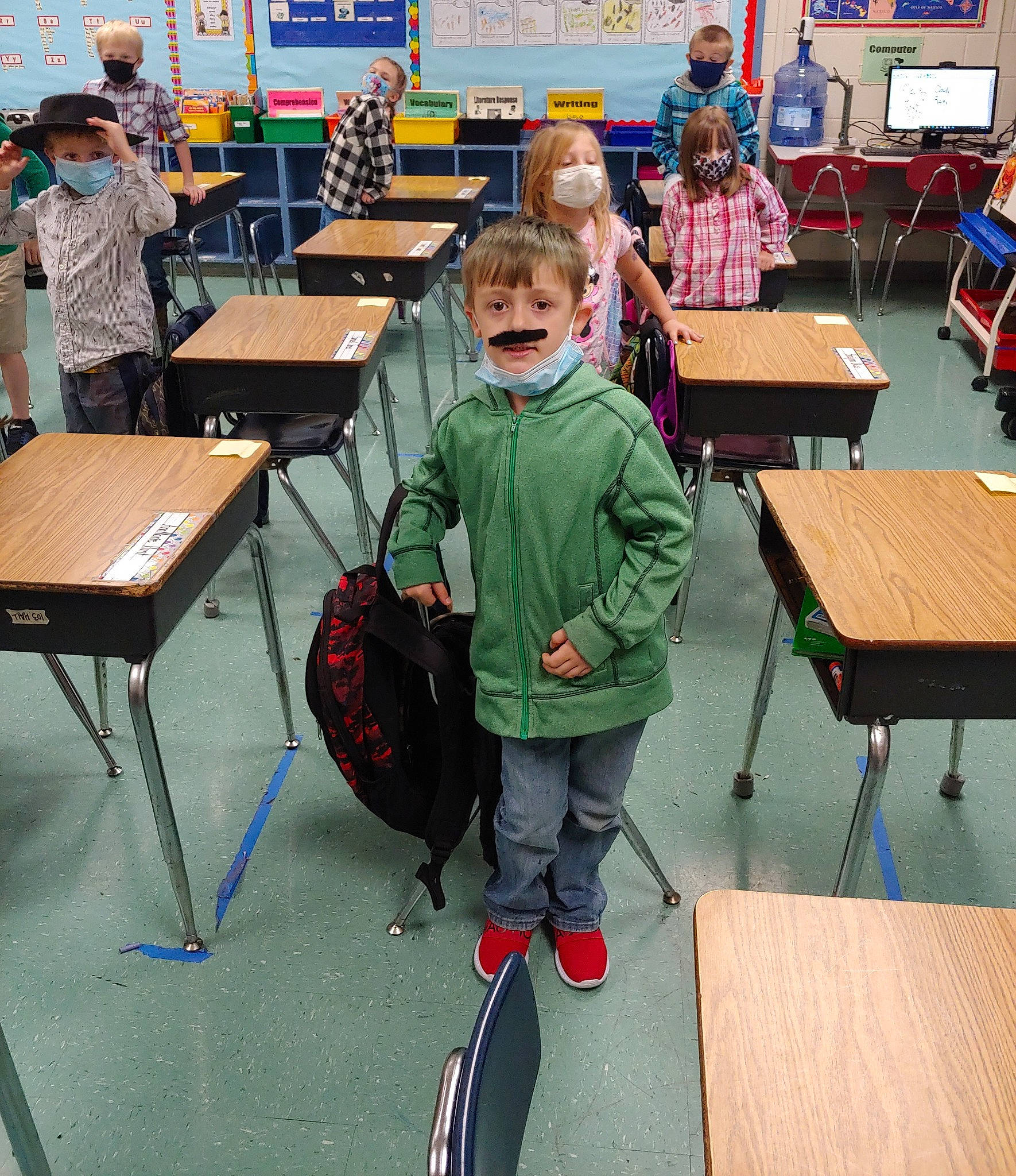 Keagen joined the competition — help win amazing prizes! academic_institution, backpack, bag, chair, child, class, clothing, desk, education, engineering, event, furniture, learning, leisure, luggage_and_bags, person, recreation, room, t_shirt, table