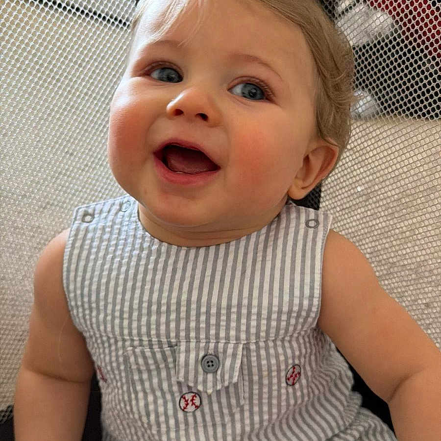 Jacob joined the competition — help win amazing prizes! baby, baseball_pattern, blue_eyes, casual, child, cute, happy, indoor, infant, mesh_netting, person, play_area, playpen, romper, rosy_cheeks, seated, smiling, striped_clothing, toddler, young_child