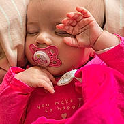 Alba participe au concours pour gagner de l'argent avec cette photo : baby, sleeping, pacifier, pink_clothing, blanket, hand, face, infant, cute, peaceful, soft_lighting, closeup, cozy, indoors, child, newborn, rest, portrait, warm_colors, toddler
