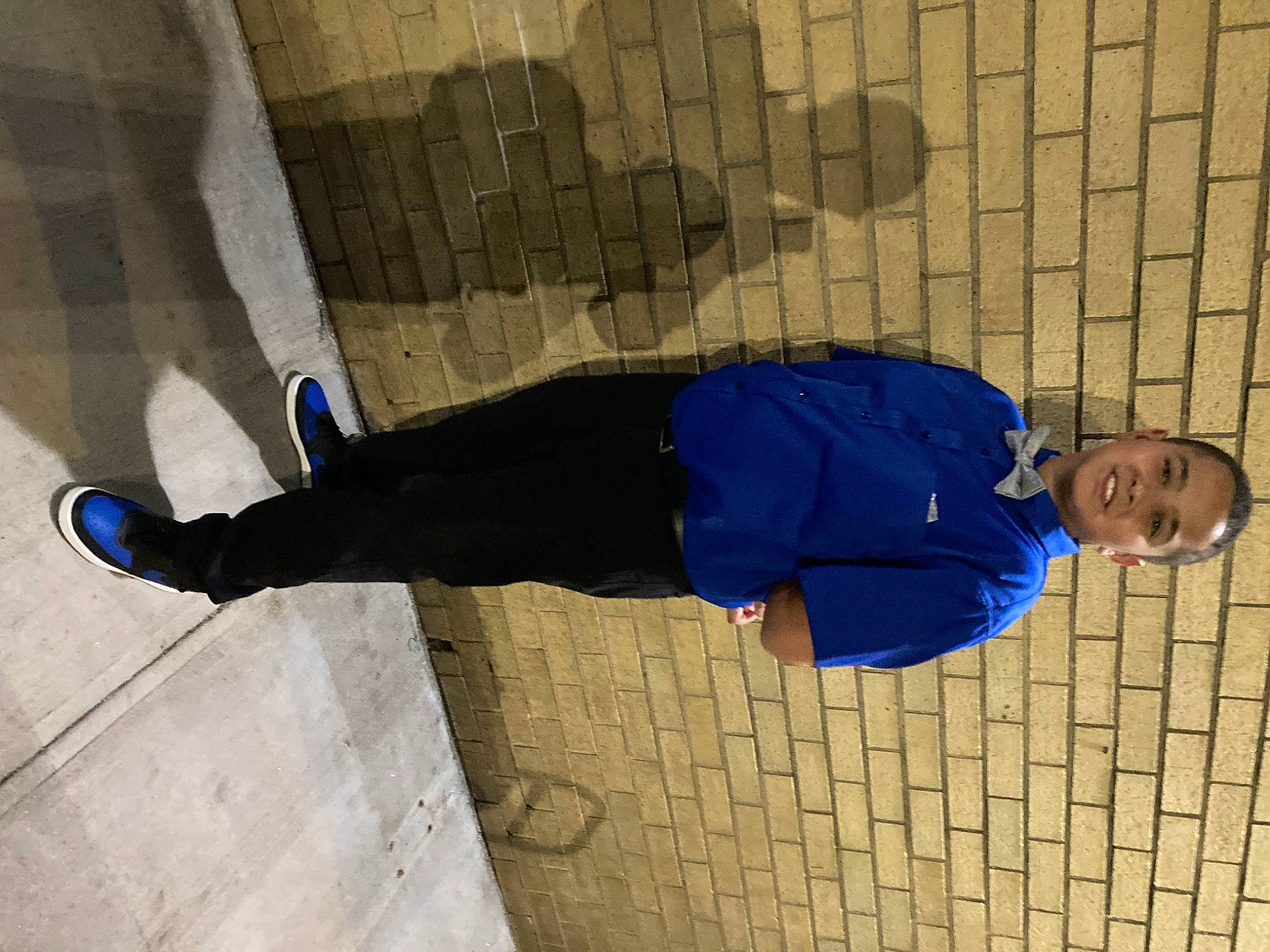 Jonathan joined the competition — help win amazing prizes! cobblestone, collar, composite_material, concrete, denim, electric_blue, flooring, foot, human_leg, joy, outdoor_shoe, pedestrian, person, road_surface, shadow, sidewalk, sitting, sleeve, smile, walking_shoe