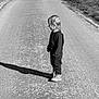 Esteban a rejoint le concours — aidez-le/la à gagner de superbes lots ! child, standing, road, shadow, black_and_white, outdoor, trees, fence, path, clothing, person, side_view, sunlight, nature, rural, quiet, alone, walking_path, small_child, casual