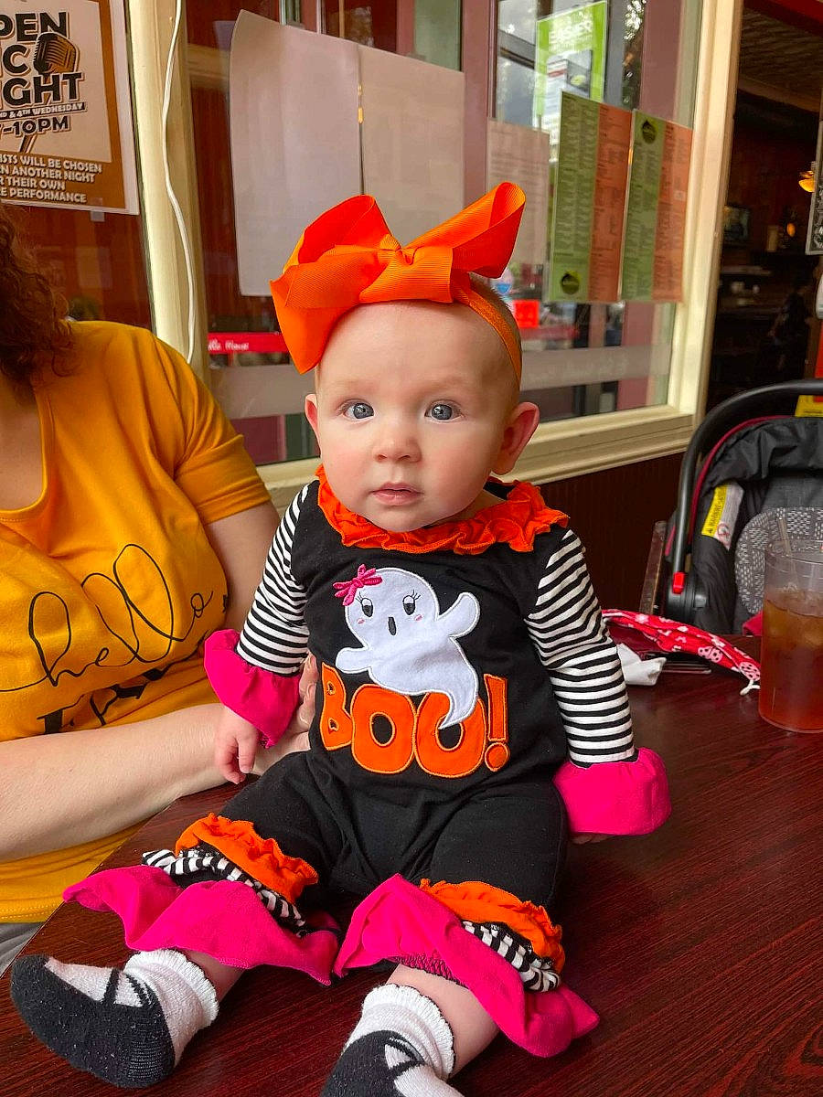 Addie joined the competition — help win amazing prizes! baby, baby_toddler_clothing, child, costume, event, flooring, fun, happy, lap, orange, party, person, pink, room, sitting, sleeve, stuffed_toy, t_shirt, tableware, toddler