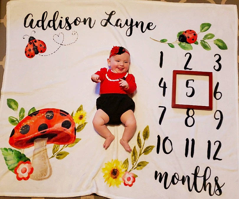 Addie is registered to the contest to win money with this photo: art, arthropod, baby_toddler_clothing, butterfly, design, font, happy, headwear, illustration, insect, joy, ladybug, mammal, pattern, person, pollinator, product, rectangle, room, smile