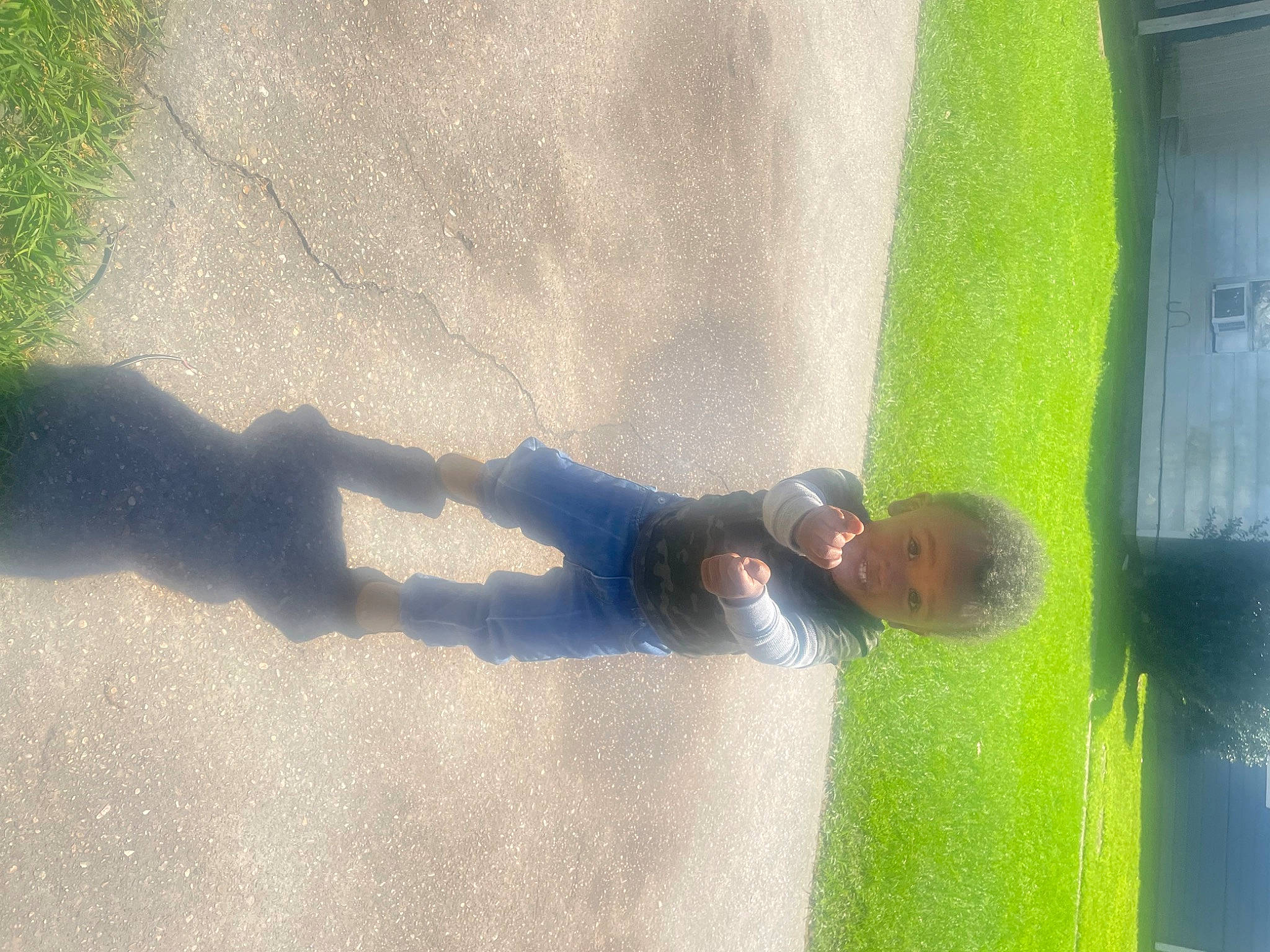 Robert is registered to the contest to win money with this photo: asphalt, concrete, flooring, foot, fun, grass, human_leg, landscape, leisure, person, recreation, reflection, road_surface, shade, shadow, sunlight, tints_and_shades, tree, water, window