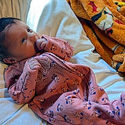 Haisley joined the competition — help win amazing prizes! newborn, baby, infant, child, portrait, face, eyes, hair, pink_outfit, onesie, bed, bedding, pillow, blanket, indoor, sunlight, lying_down, sucking_fist, cozy, photography