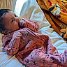 newborn, baby, infant, child, portrait, face, eyes, hair, pink_outfit, onesie, bed, bedding, pillow, blanket, indoor, sunlight, lying_down, sucking_fist, cozy, photography