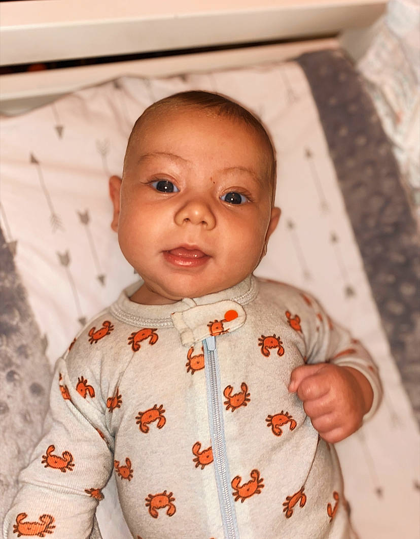 Brendan is registered to the contest to win money with this photo: baby, baby_toddler_clothing, cheek, child, eye, face, head, lip, outerwear, people, person, skin, sleeve, smile, toddler