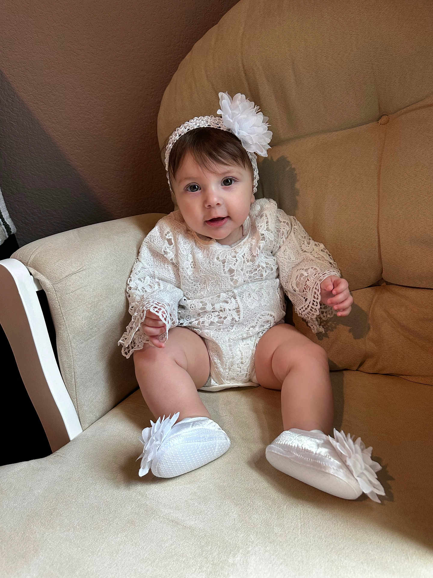 Mckenna is registered to the contest to win money with this photo: baby, infant, child, lace, headband, flower, white_clothing, shoes, cushion, chair, indoor, portrait, cute, sitting, soft_lighting, smile, happy, furniture, person, closeup