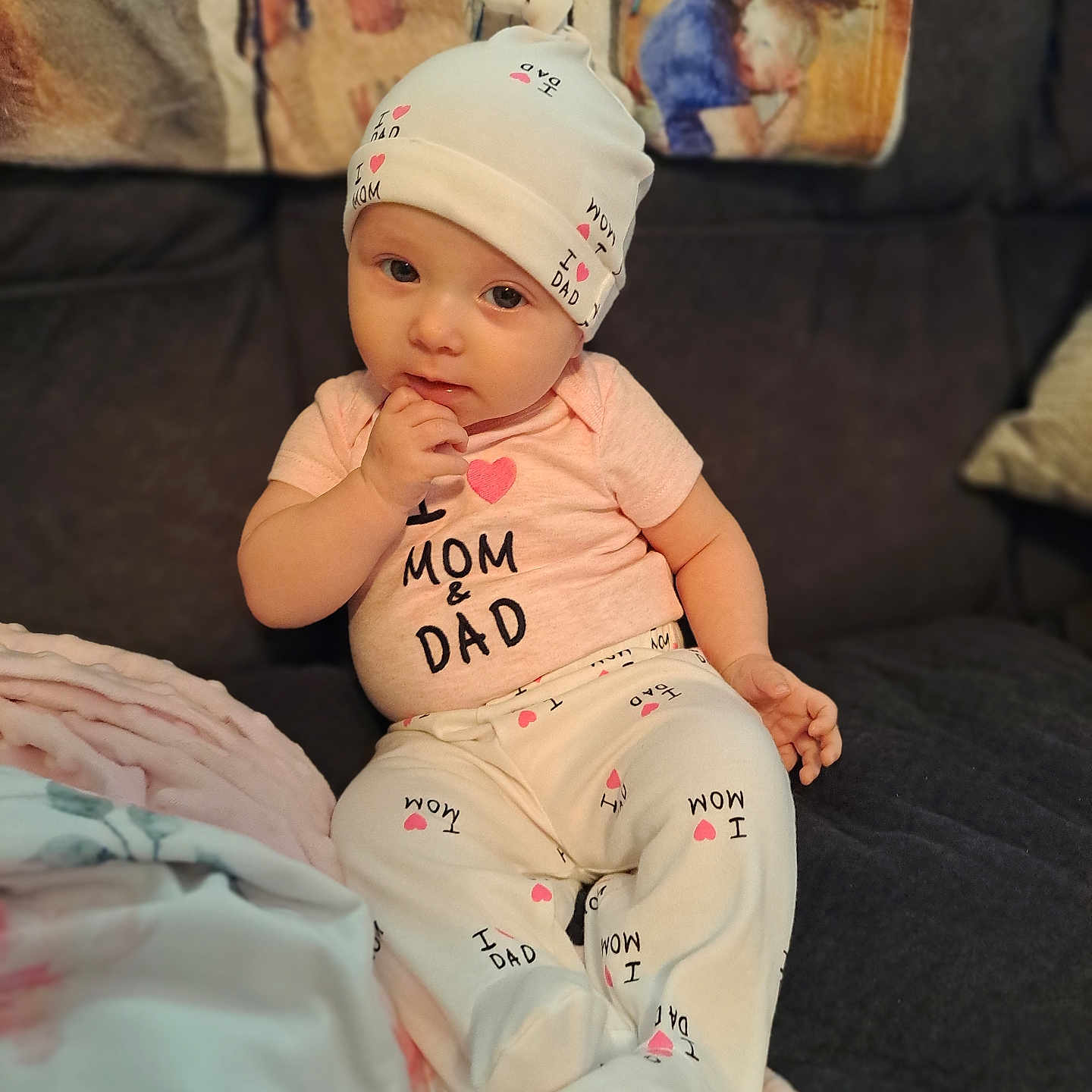 Neva is registered to the contest to win money with this photo: adult, baby, bonnet, cap, clothing, couch, cushion, face, female, furniture, hat, head, homedecor, indoors, newborn, pants, person, photography, portrait, woman