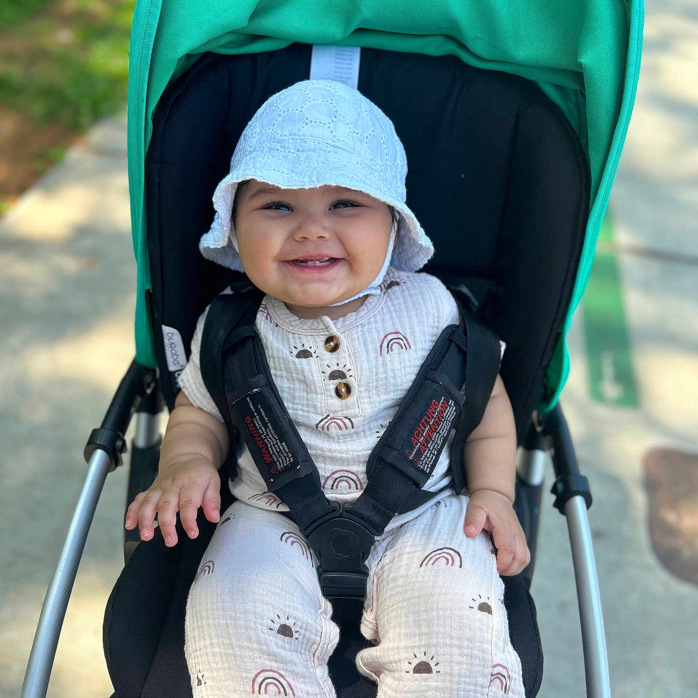 Amelia is registered to the contest to win money with this photo: accessories, baby, bonnet, cap, clothing, coat, face, happy, hat, head, hood, jacket, pants, person, photography, portrait, smile, stroller, sunglasses, sunhat