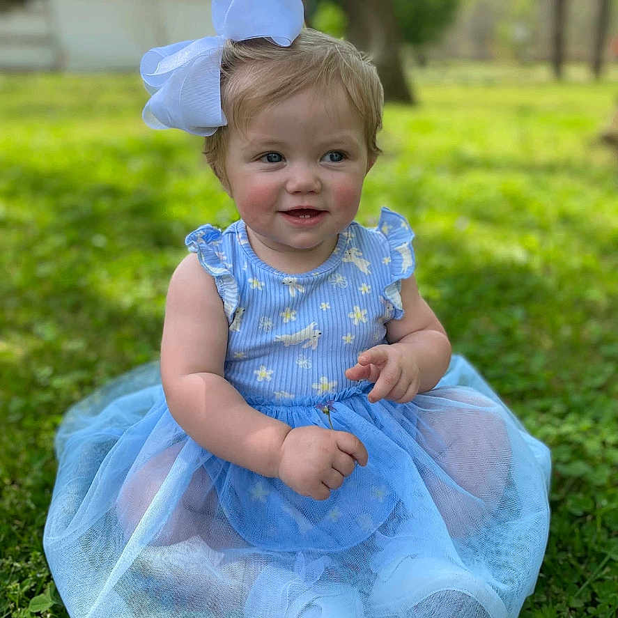 Ruby joined the competition — help win amazing prizes! baby, backyard, clothing, costume, dress, face, formalwear, grass, hat, head, lawn, nature, outdoors, park, person, photography, plant, portrait, sitting, yard