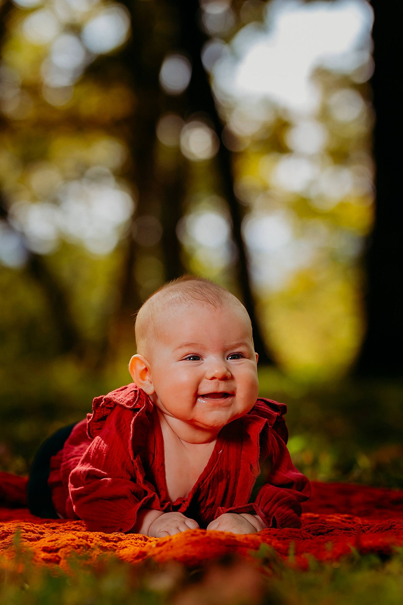 Kira is registered to the contest to win money with this photo: baby, baby_toddler_clothing, branch, cheek, child, eye, face, flash_photography, grass, happy, head, leisure, natural_landscape, people_in_nature, person, plant, smile, sunlight, toddler, tree