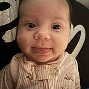 Myka is registered to the contest to win money with this photo: baby, close_up, face, tongue_out, onesie, button, animal_print, ribbed_fabric, infant, cute, expression, child, portrait, indoor, soft_lighting, happy, young, person, clothing, smile