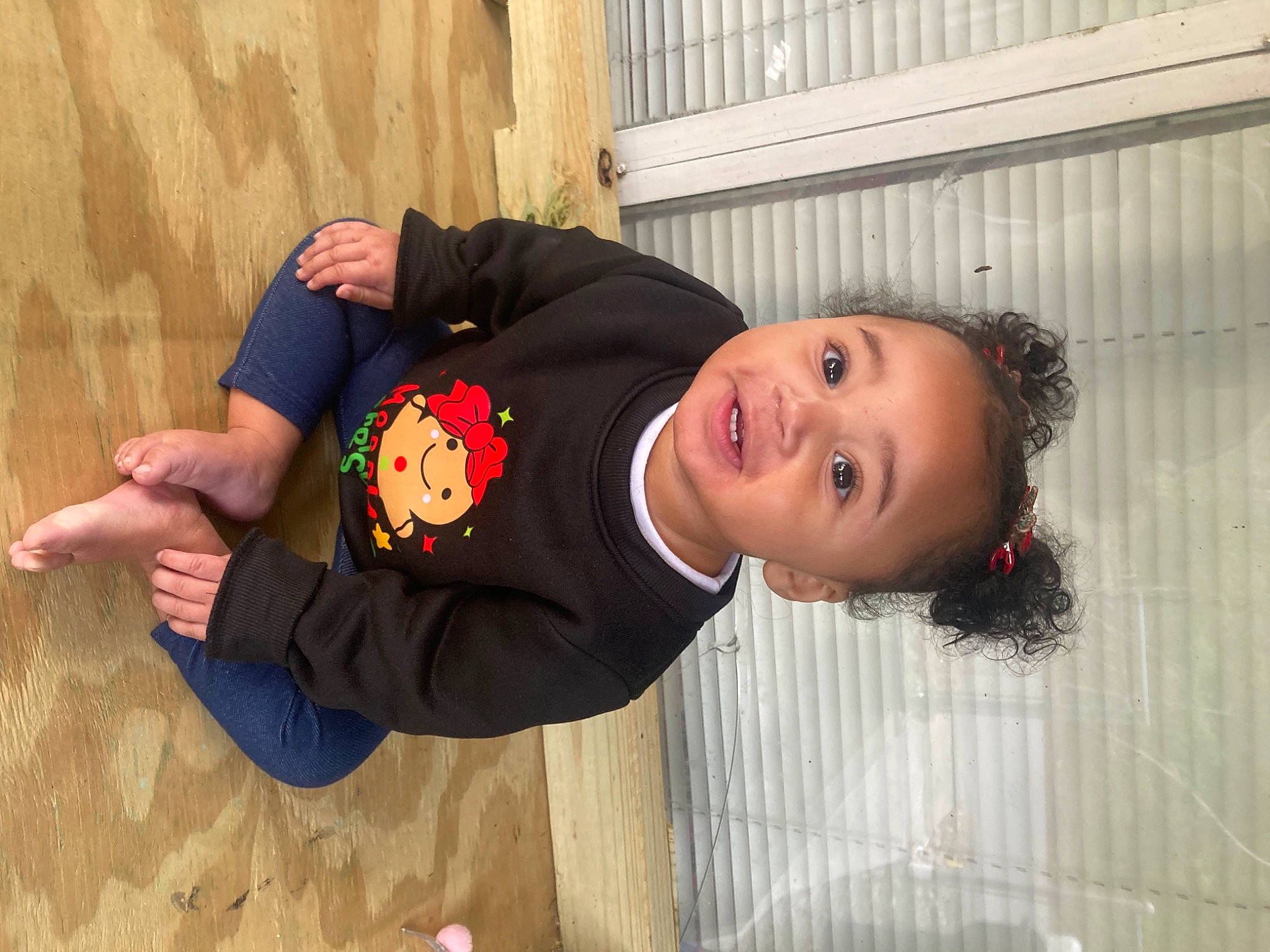 Zalia is registered to the contest to win money with this photo: baby_toddler_clothing, child, face, fun, gesture, happy, person, sitting, sleeve, smile, toddler, tree, wood
