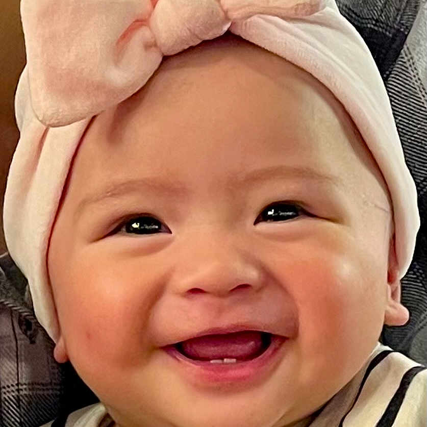 Zahra Nicole participe au concours pour gagner de l'argent avec cette photo : adorable, apparel, baby, bow, cheeks, child, closeup, cute, face, happy, headband, indoor, infant, person, portrait, skin, smiling, striped_clothing, teeth, young_child