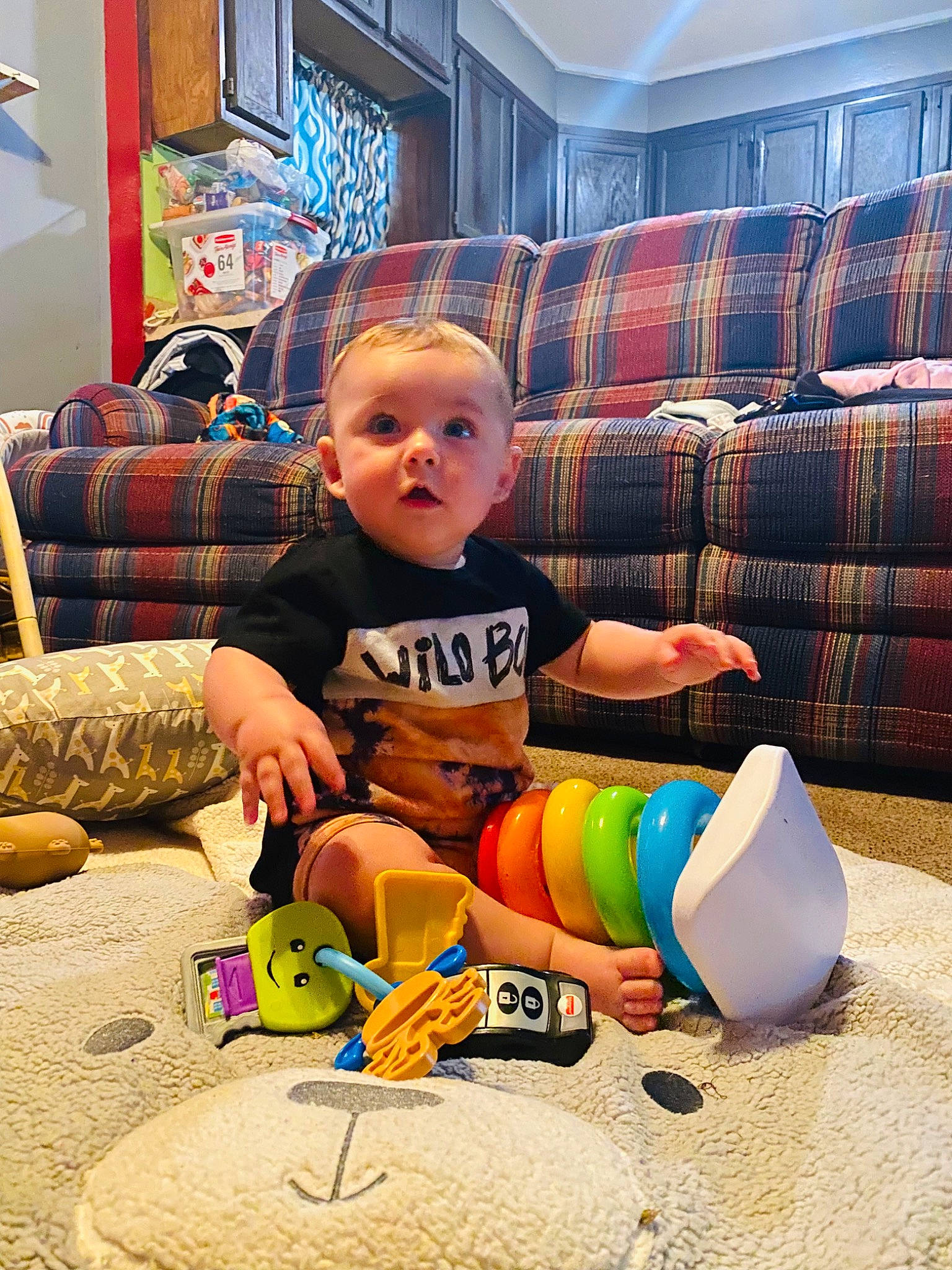 Boone joined the competition — help win amazing prizes! baby, baby_toddler_clothing, child, comfort, couch, event, flooring, fun, happy, hardwood, lamp, living_room, person, picture_frame, pillow, play, room, sitting, studio_couch, surprise