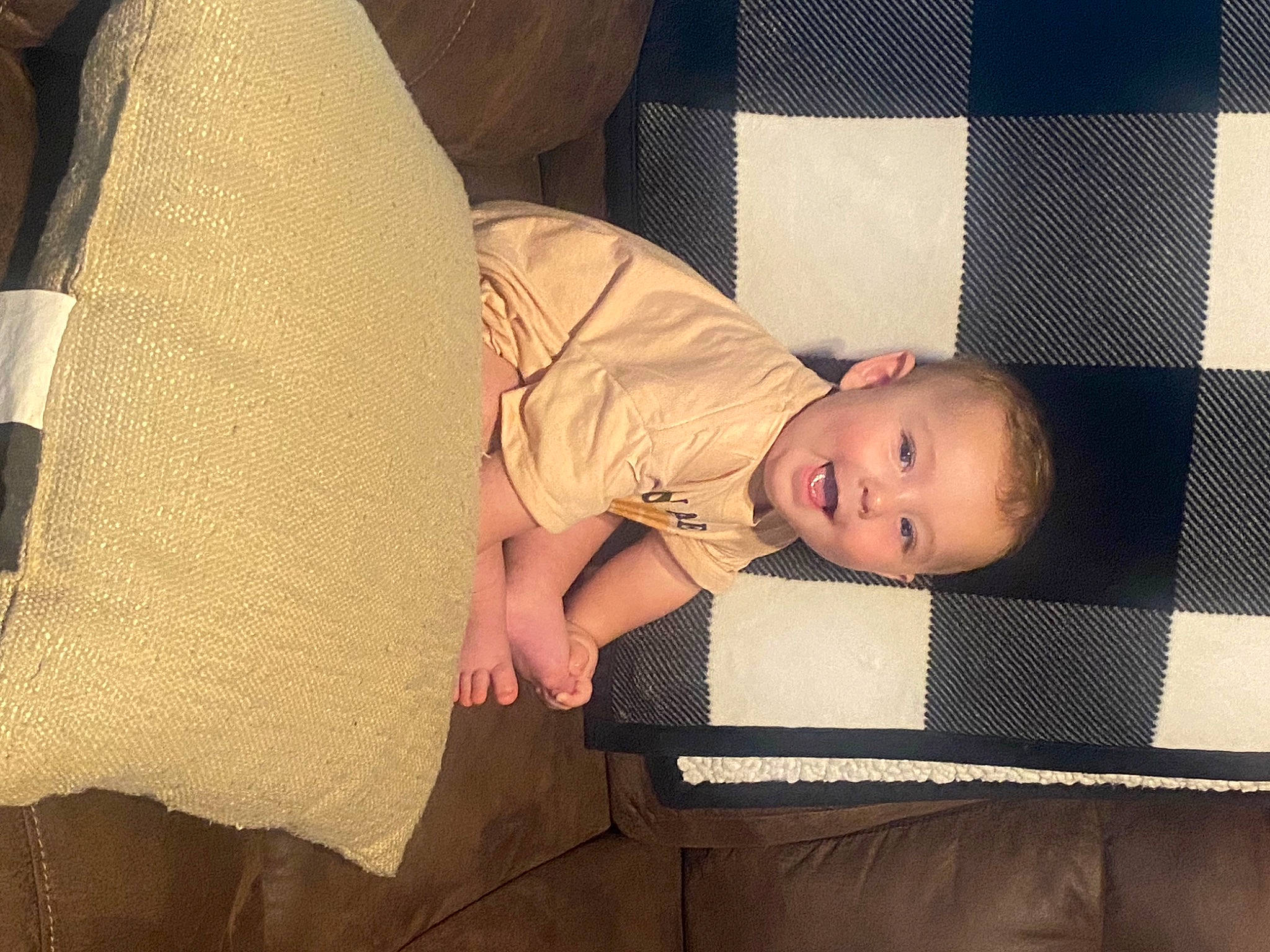 Boone is registered to the contest to win money with this photo: baby, baby_products, baby_toddler_clothing, cheek, child, comfort, couch, finger, flooring, human_leg, linens, pattern, person, room, sitting, skin, sock, thigh, tints_and_shades, toddler