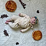 baby, infant, crown, pastry, blanket, white_background, leaf_shape, heart_shape, clothing, milestone, months, number, face, lying_down, cute, soft_texture, decorations, celebration, portrait, child