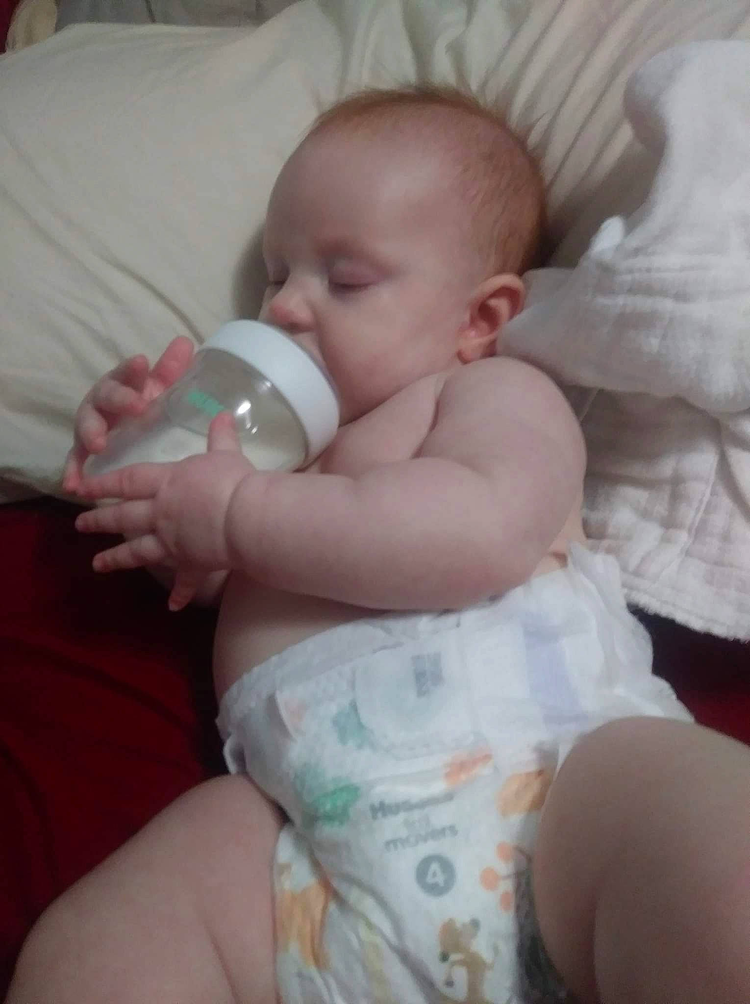 Salem is registered to the contest to win money with this photo: arm, baby, baby_toddler_clothing, cheek, comfort, drinkware, ear, eye, finger, gesture, hand, head, human_body, iris, mammal, mouth, nose, person, product, skin