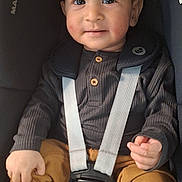 Idrees is registered to the contest to win money with this photo: baby, child, car_seat, safety_harness, smiling, cute, infant, clothing, seatbelt, portrait, indoors, young_child, hands, feet, buttoned_shirt, casual_wear, sitting, happy, face, human