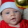 Maël a rejoint le concours — aidez-le/la à gagner de superbes lots ! baby, infant, face, santa_hat, christmas, holiday, ornament, red_clothing, blue_eyes, close_up, cute, festive, soft_texture, blanket, indoors, holiday_season, child, portrait, expression, curious