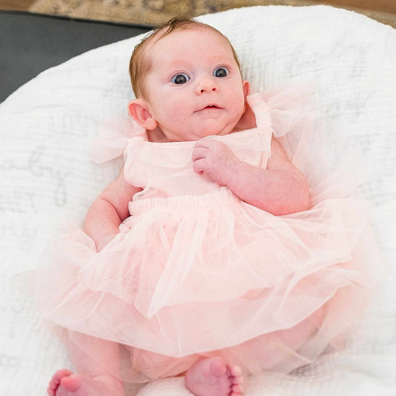 Stella True is registered to the contest to win money with this photo: baby, bed, bedroom, blanket, clothing, cushion, dress, face, furniture, head, homedecor, indoors, newborn, pants, person, photography, portrait, room, sitting, sleeping